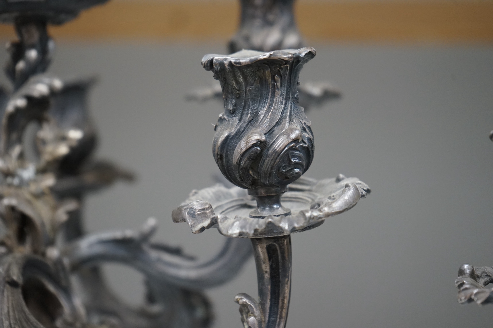 A pair of silver plated Rococo style six branch, seven light candelabra, 49cm. Condition - fair to good